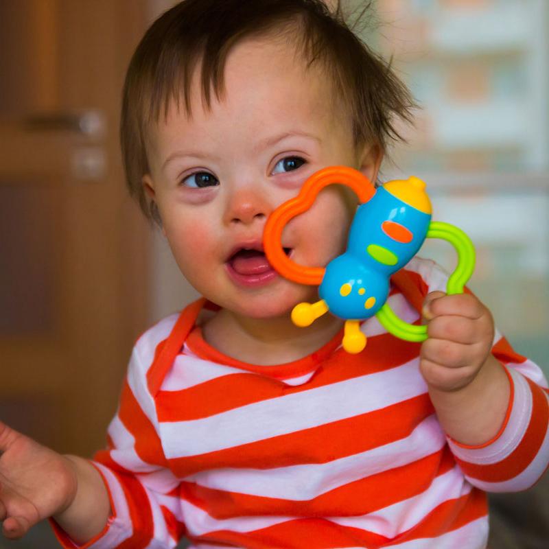 baby smiling with toy