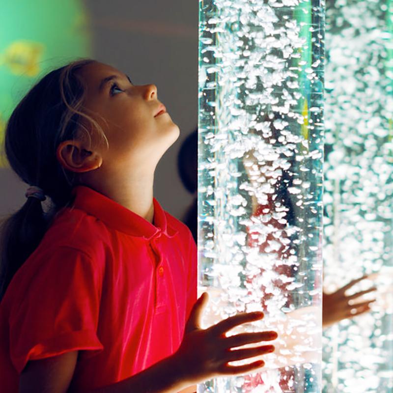 Girl looking at a bubble tower