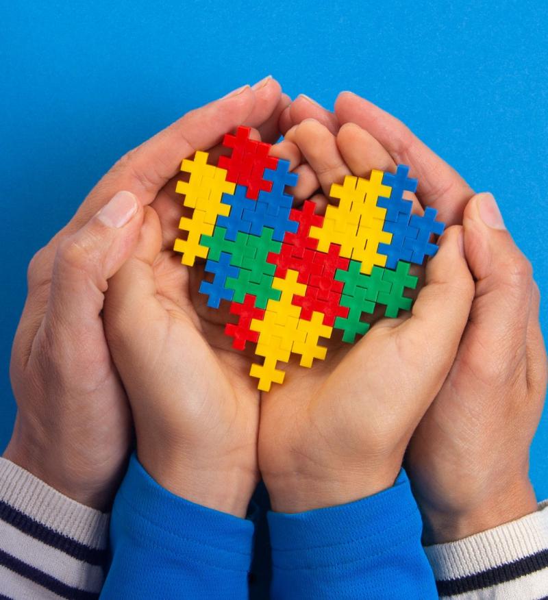 Childrens and parents hands holding puzzle pieces