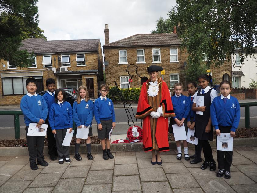 The Worshipful Mayor of Barnet, Councillor Caroline Stock, with children from Northside Primary School next to the new Lodge Lane Tommy sculpture in North Finchley.