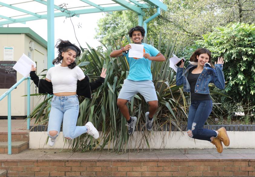 A socially distanced celebration: Students from The Compton School jump for joy after receiving their results