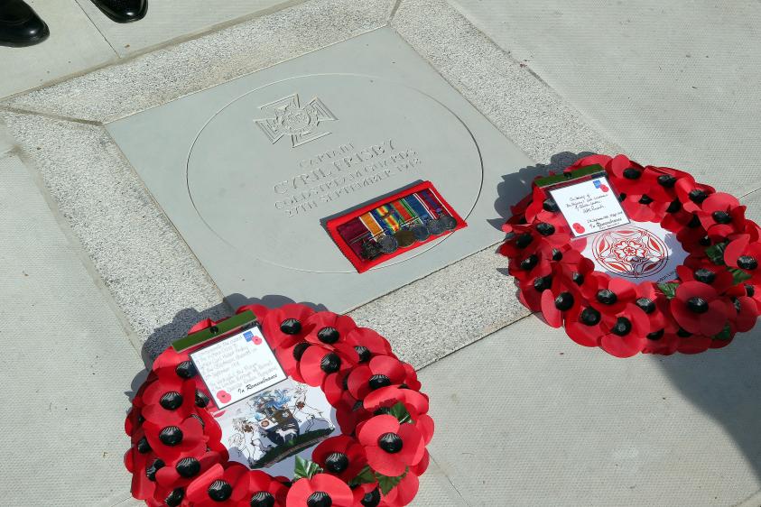 Paving stone tribute to Captain Cyril Hubert Frisby with poppy wreaths