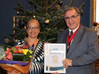 Pam Decaine receiving her award from the deputy mayor of Barnet, Cllr Tony Vourou