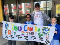 Barnet Council’s Steve Marshall is welcomed by children at Blessed Dominic Catholic School in Colindale during his charity walking challenge.