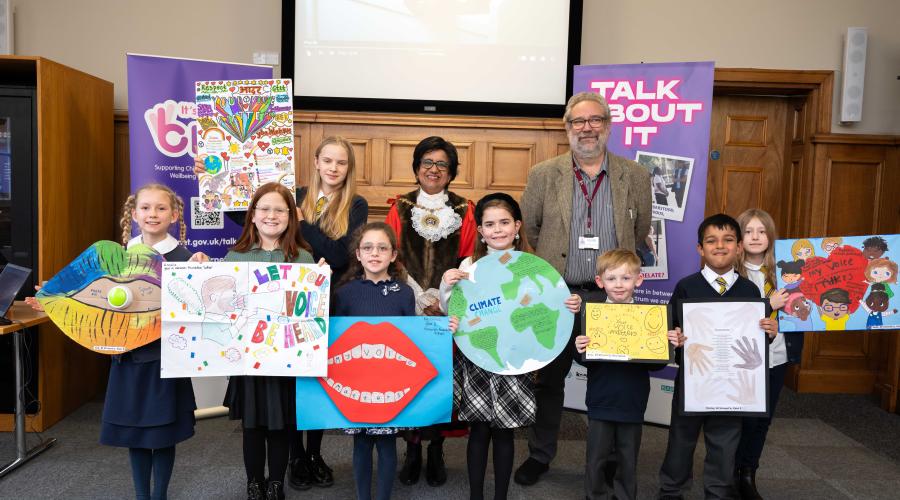 The pupils, with their winning posters, are congratulated by the Worshipful Mayor of Barnet, Cllr Nagus Narenthira, and Chris Munday, Executive Director of Children Services 